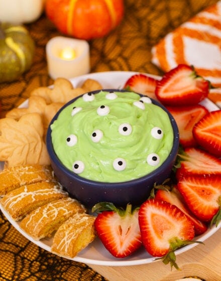 An image of Alyssia's green monster marshmallow dip, covered with candy eyes and surrounded by dippers.