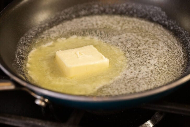 A black pan with melting butter.