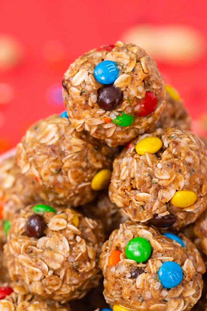 A close up shot of a pile of protein balls without dates on a red table setting.