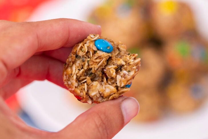 Alyssia holding up a single no-date protein ball to show off the texture and size.
